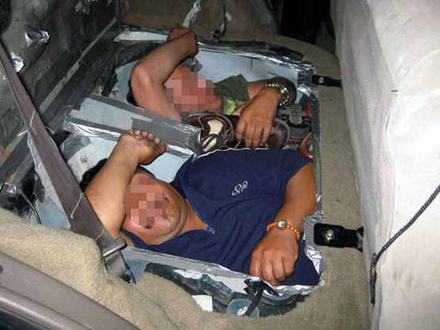 Illegal immigrants found in compartments in the floor of a car.