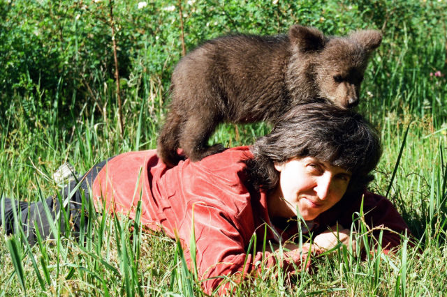 Latvian Woman Raises Wild Bear Cub Alongside Her Children