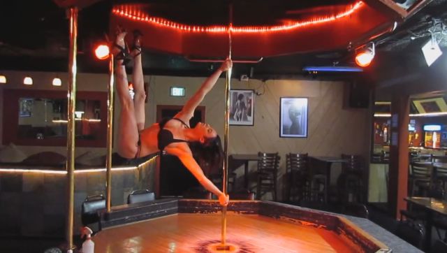 Talented Acrobatic Pole Dancer Practicing While the Strip Cub Is Empty