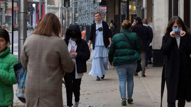 Correspondent Walks Through London Streets Wearing A Long Dress