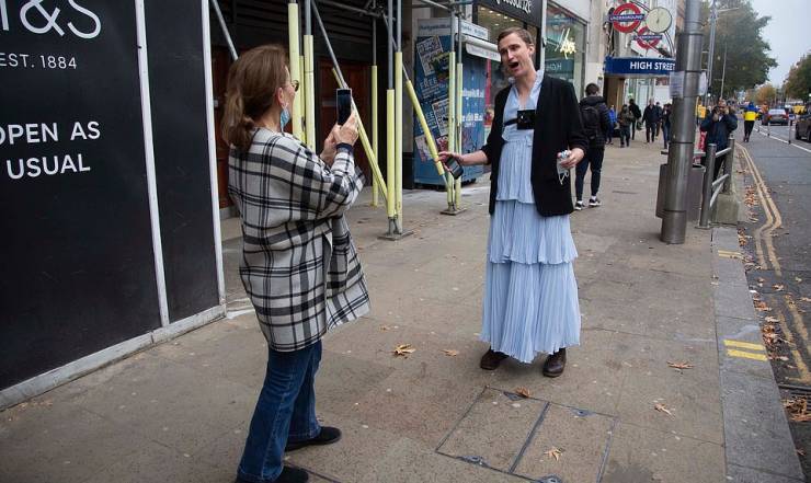 Correspondent Walks Through London Streets Wearing A Long Dress