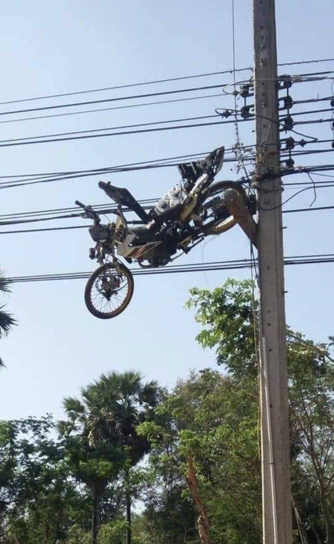 Motorcycle stuck in the wiring harness on the pole.