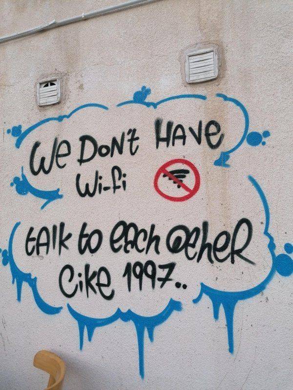 Wall message saying: "We do not have Wi-fi, talk to each other like 1997".