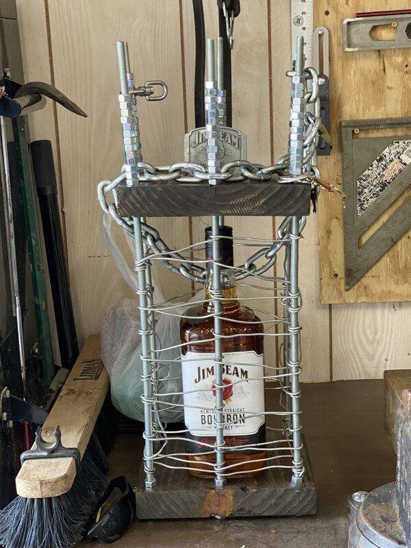 A Jim Beam bottle hidden in a cage under lock and key.