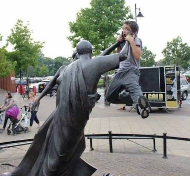 People Goofing Around With Statues