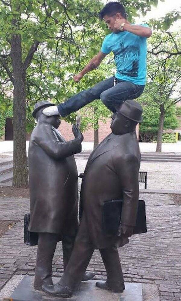 People Goofing Around With Statues