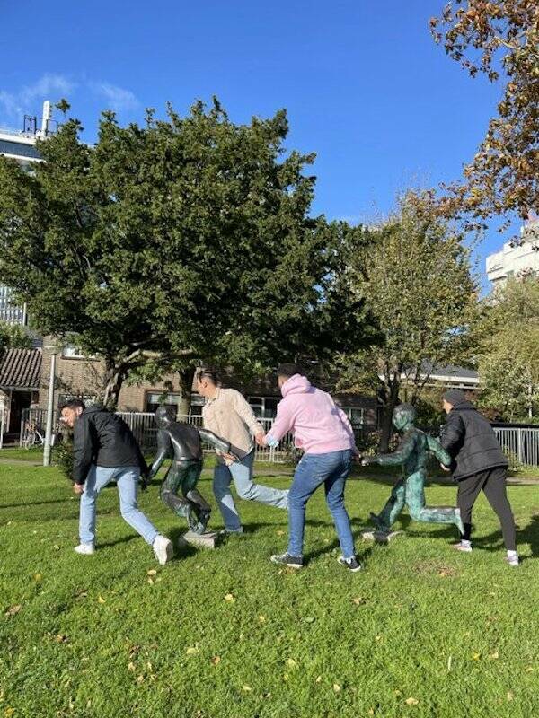 People Goofing Around With Statues