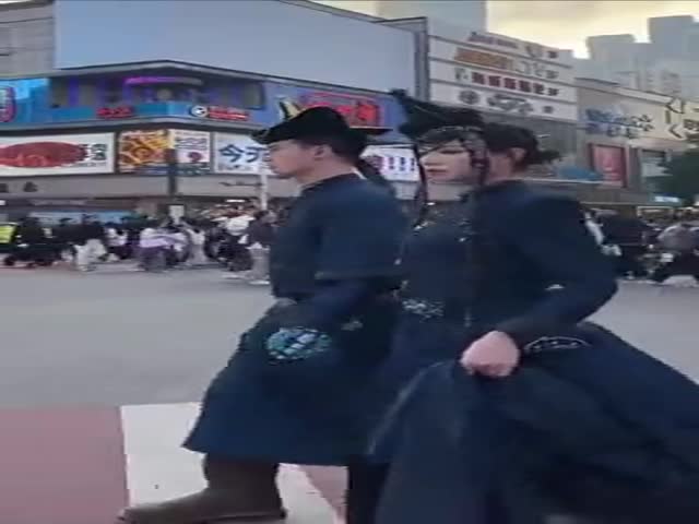 A Couple From China Walking Around The City In Traditional Clothes