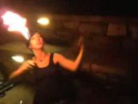 Girl Lights Torch with Own Bare Arm