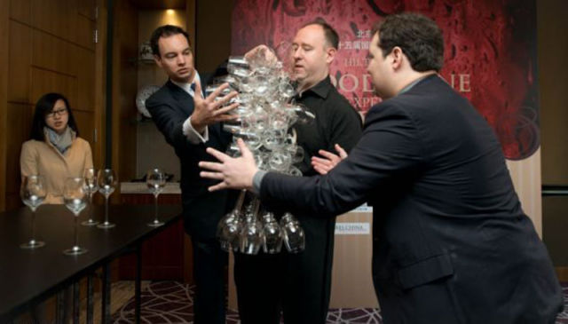 Wine Expert Sets World Record for Holding Wine Glasses!