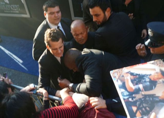 Brad Pitt Becomes a Victim of the Red Carpet Crasher at Maleficent Premiere