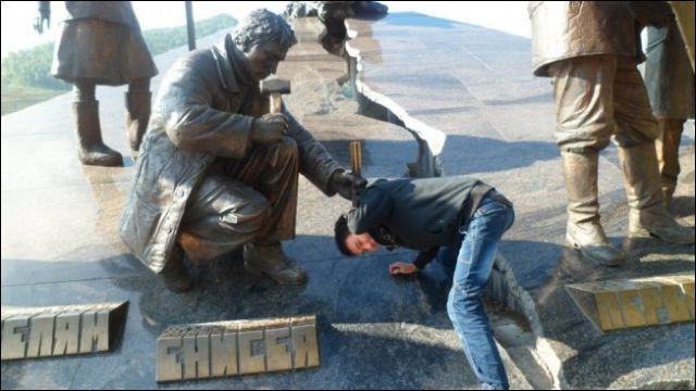 People Joking around with Statues and Monuments