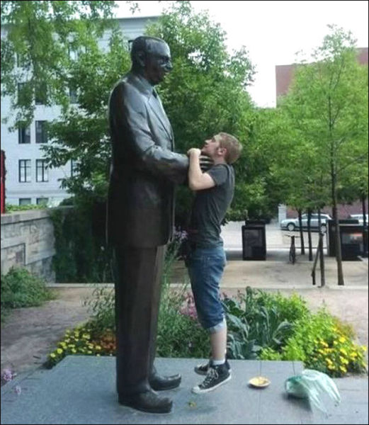 People Joking around with Statues and Monuments