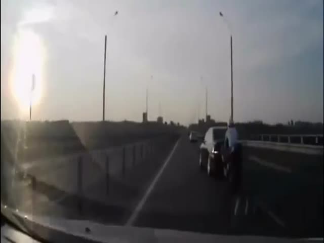 Something Crazy Happens While Speeding Biker Crashes into Car  (VIDEO)