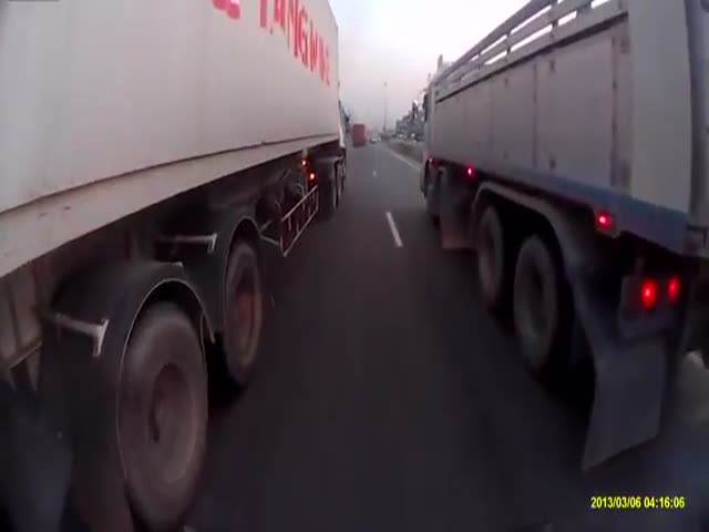 Scooter Rider Crashes between Two Trucks, Miraculously Survives  (VIDEO)