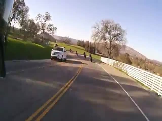 Biker Goes Airborne after Avoiding Head-on Collision  (VIDEO)