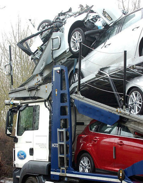 A Bridge Collision Squashes a Trailer Full of New Cars