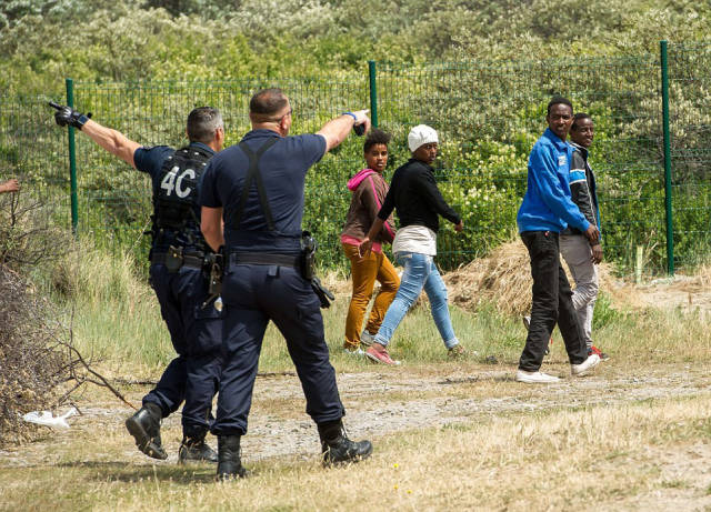 Riot Police Try to Stop Hundreds of Migrants from Crossing into the UK