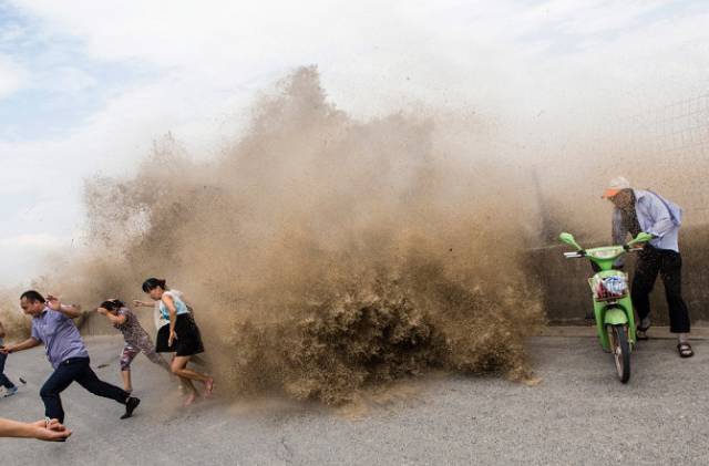 Chinese Locals Dodge Death By Getting Scarily Close to a Tidal Wave for Fun