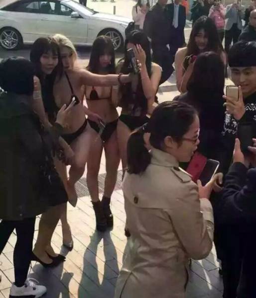 Chinese Mobile Company Uses Near Naked Models to Introduce Their New App to the World