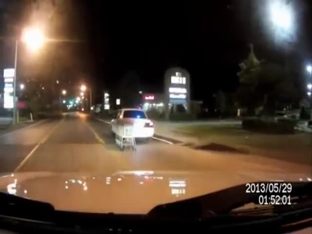 Two Police Have a Little Late Night Fun Returning Shopping Carts to a Local Business
