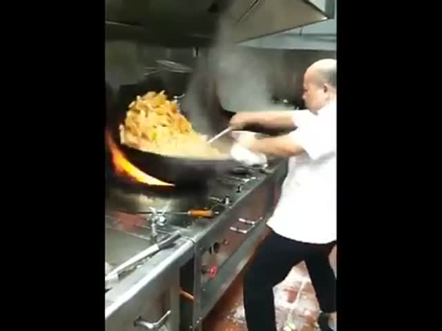 Great Technique Of A Chef Cooking With An Enormous Wok